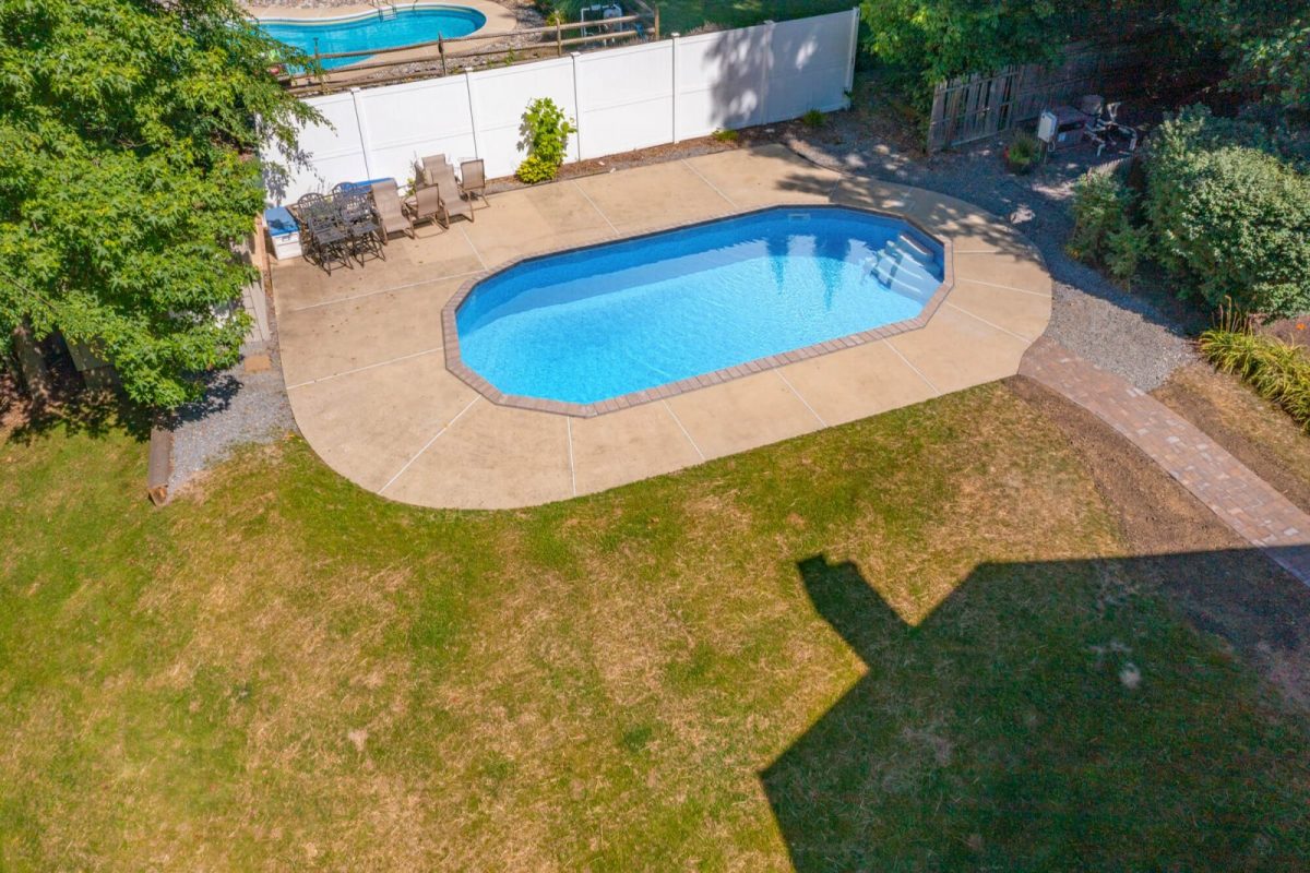 The same pool with the cover removed, showing clear blue water