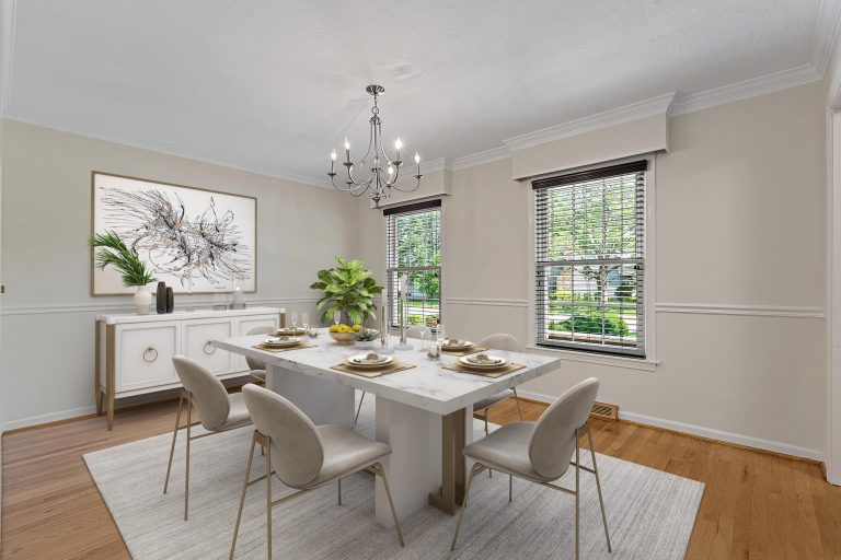 The same dining room virtually staged with a marble table, chairs, sideboard, rug and artwork