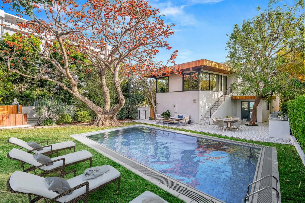 Backyard with a virtually added pool and sun loungers beside a modern two-storey house