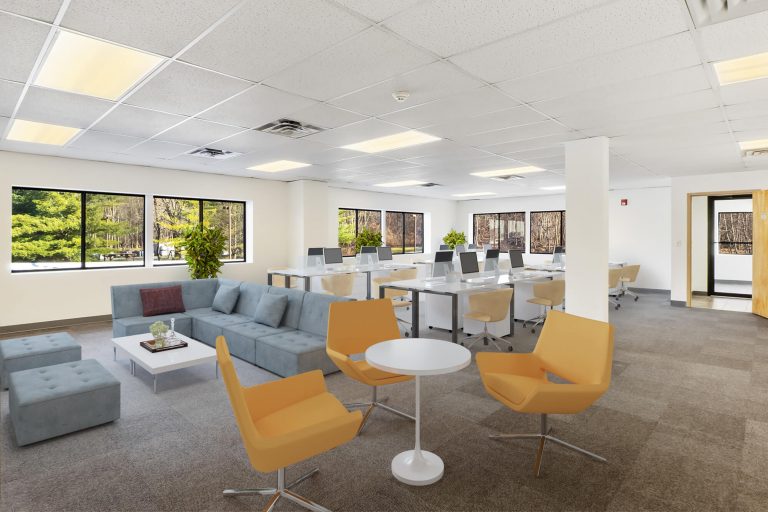 The same office staged with workstations, a lounge and meeting seating