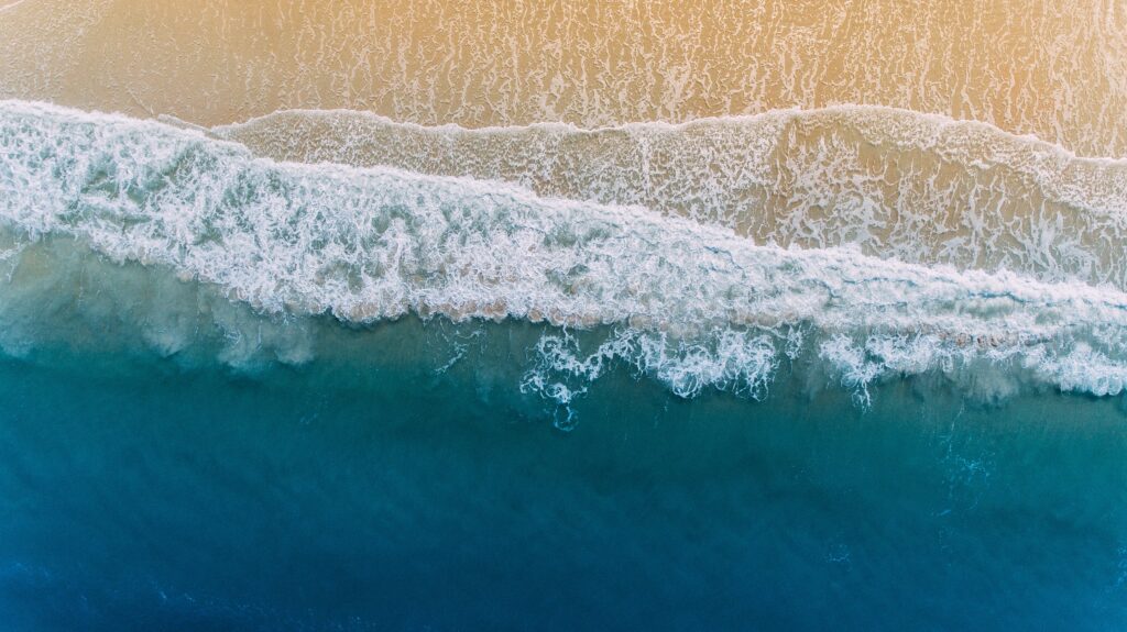 Aerial view of ocean waves on a sandy beach